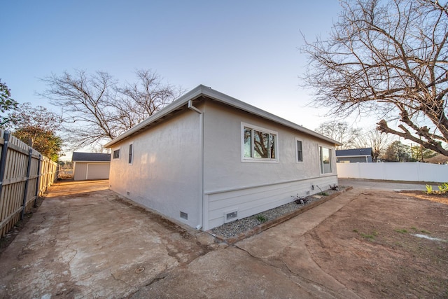 property exterior at dusk with a patio