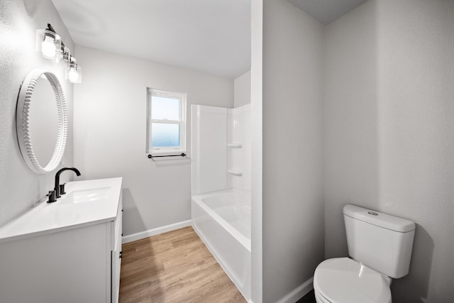 full bathroom featuring vanity, hardwood / wood-style flooring, toilet, and shower / bath combination