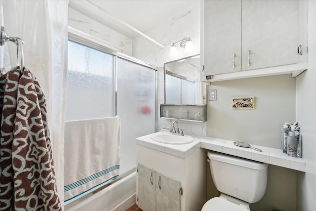 full bathroom with vanity, toilet, and combined bath / shower with glass door