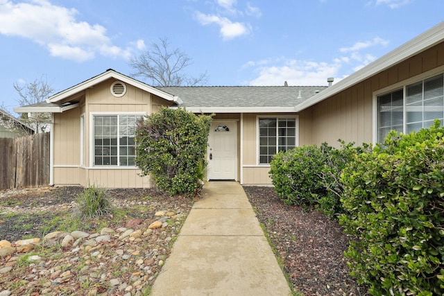 view of exterior entry featuring fence