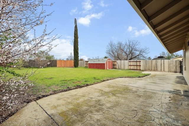 view of yard with a fenced backyard, a patio, an outdoor structure, and a storage shed