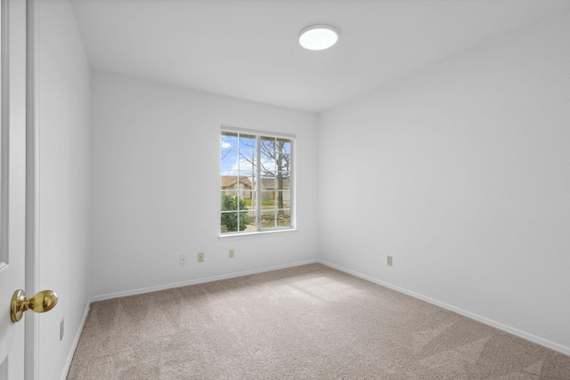 carpeted empty room with baseboards