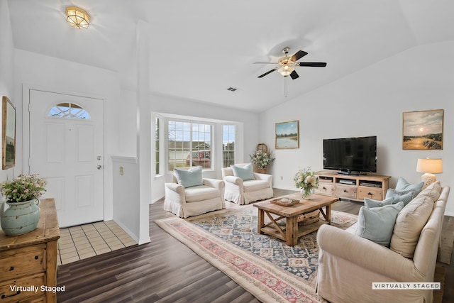 living room with ceiling fan, visible vents, vaulted ceiling, and wood finished floors