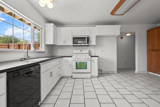 kitchen with a sink, stainless steel microwave, gas range gas stove, black dishwasher, and white cabinetry