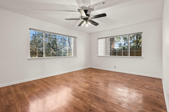 unfurnished room with wood-type flooring, baseboards, and ceiling fan