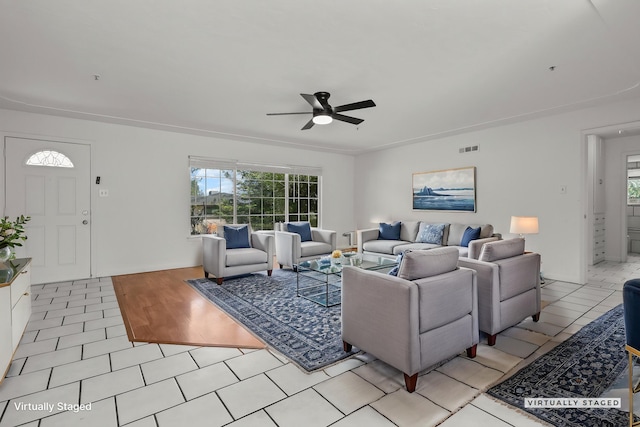 living room with visible vents, light tile patterned floors, ceiling fan, and a healthy amount of sunlight
