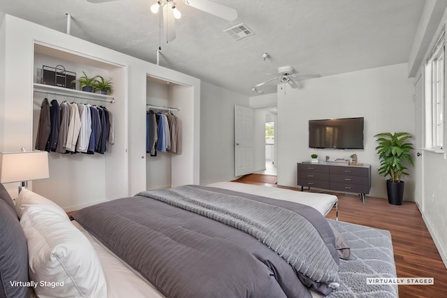 bedroom featuring wood finished floors, visible vents, baseboards, and ceiling fan