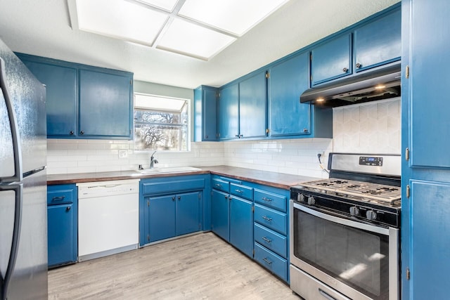 kitchen featuring gas range, fridge, blue cabinets, and dishwasher