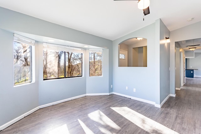 spare room featuring dark wood-type flooring and ceiling fan