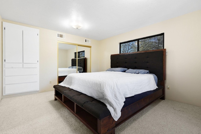 bedroom featuring light colored carpet and a closet