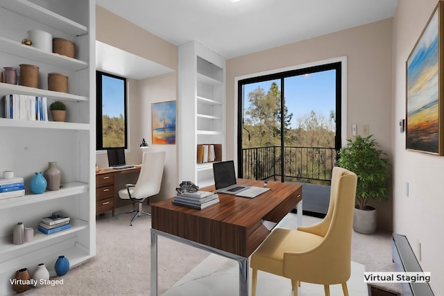 carpeted office space featuring built in shelves