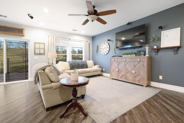 living room featuring hardwood / wood-style floors and ceiling fan