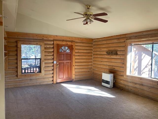 entrance foyer with heating unit, lofted ceiling, log walls, dark colored carpet, and ceiling fan