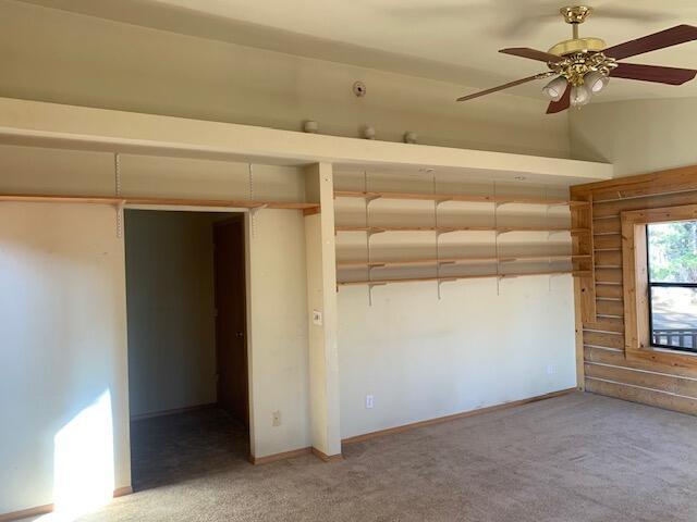 interior space featuring carpet floors and ceiling fan