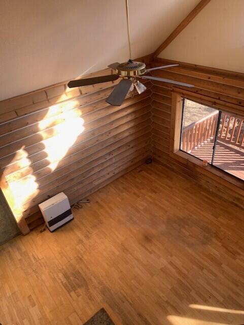 unfurnished room with lofted ceiling, hardwood / wood-style flooring, and ceiling fan