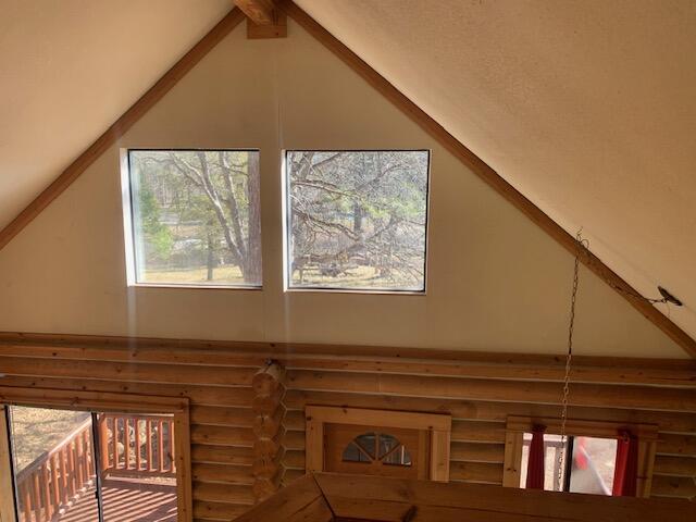 interior details featuring beamed ceiling and log walls