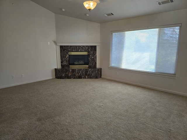 unfurnished living room with carpet floors and a high end fireplace