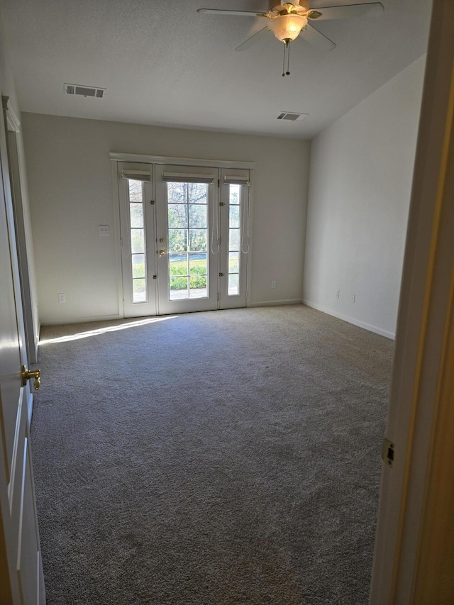 carpeted spare room with ceiling fan