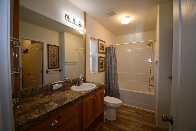 full bathroom with hardwood / wood-style flooring, vanity, toilet, and shower / bath combination with curtain