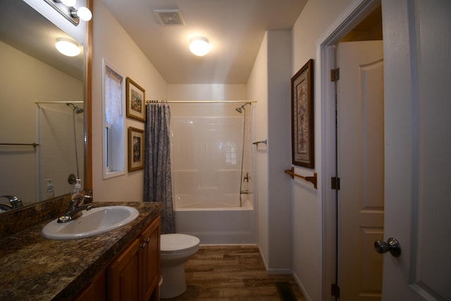 full bathroom with wood-type flooring, toilet, shower / tub combo, and vanity