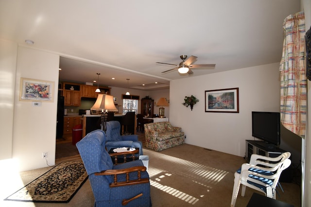 carpeted living room featuring ceiling fan