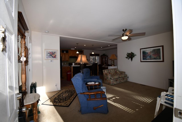 carpeted living room featuring ceiling fan