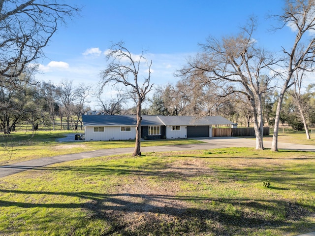 view of front of house featuring a garage and a front lawn