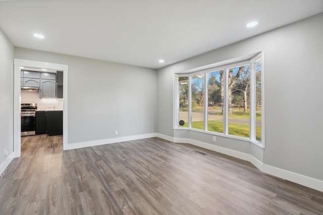 unfurnished room featuring dark hardwood / wood-style flooring