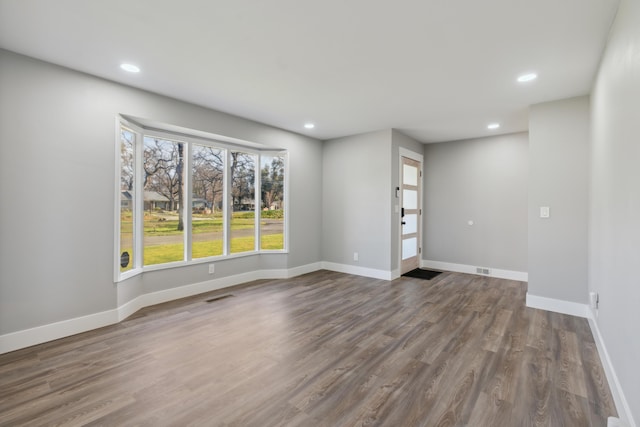 spare room featuring wood-type flooring