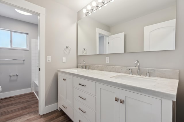 bathroom featuring shower / bath combination, vanity, and wood-type flooring