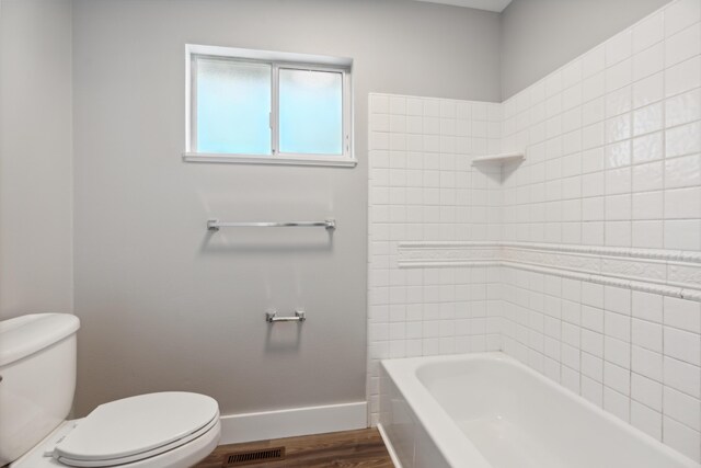 bathroom with hardwood / wood-style flooring and toilet