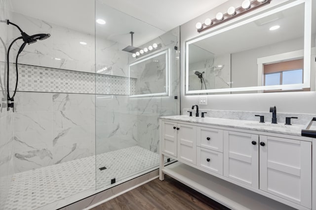 bathroom featuring vanity, tiled shower, and hardwood / wood-style floors