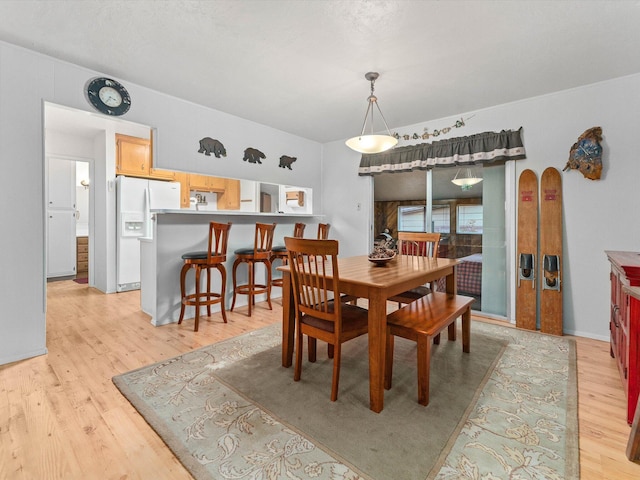 dining space with light wood-type flooring