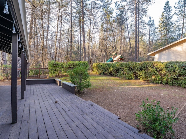 wooden deck featuring a playground