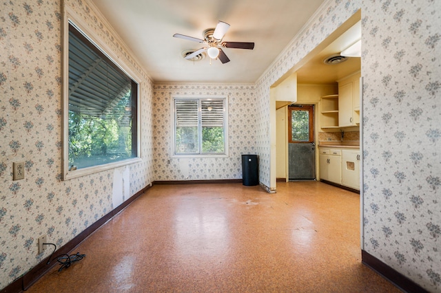 spare room with crown molding and ceiling fan