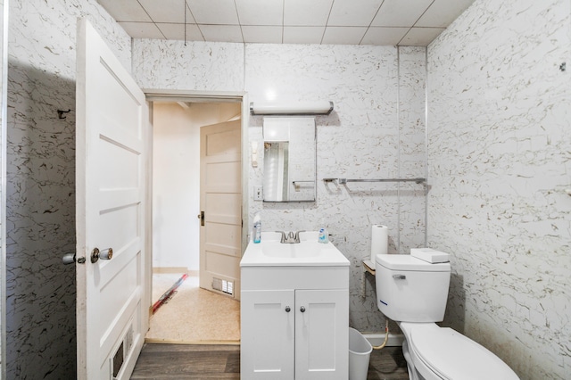 bathroom featuring vanity, hardwood / wood-style floors, and toilet