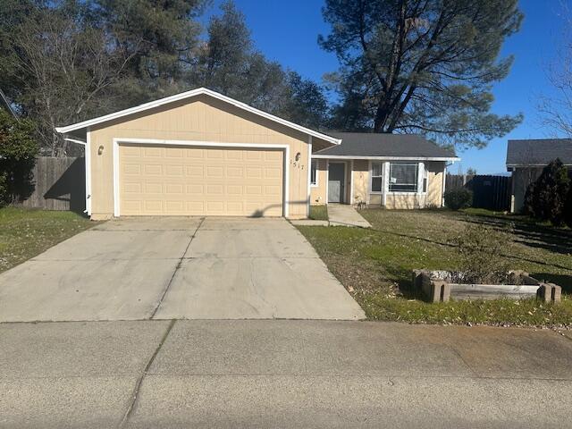 single story home featuring a garage and a front lawn