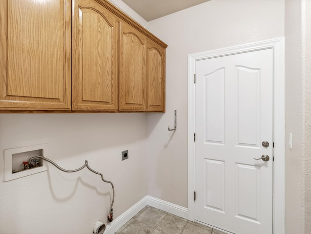 laundry room featuring cabinets, hookup for a washing machine, hookup for an electric dryer, and hookup for a gas dryer