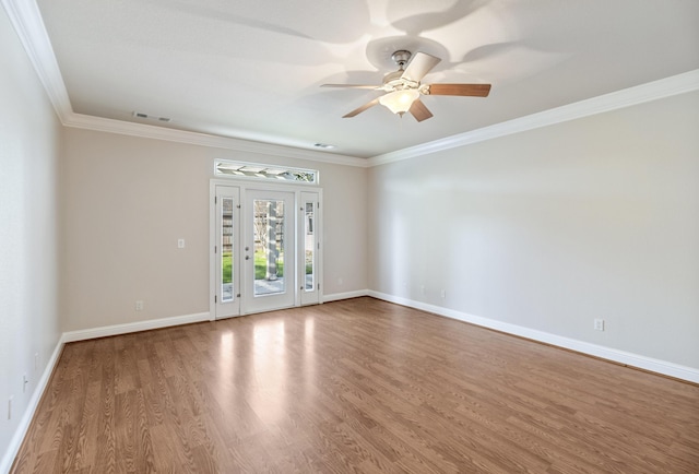 empty room with crown molding, hardwood / wood-style floors, and ceiling fan