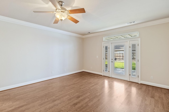 spare room with crown molding, ceiling fan, and light hardwood / wood-style flooring