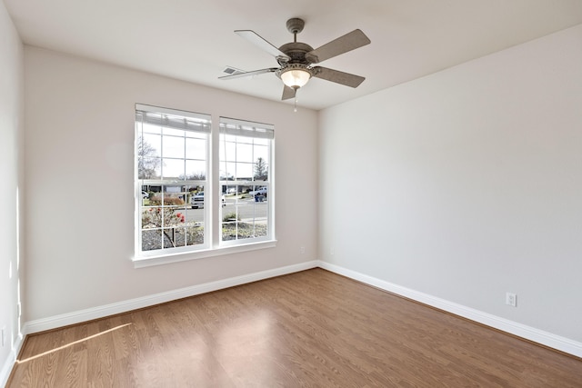 unfurnished room with hardwood / wood-style flooring and ceiling fan