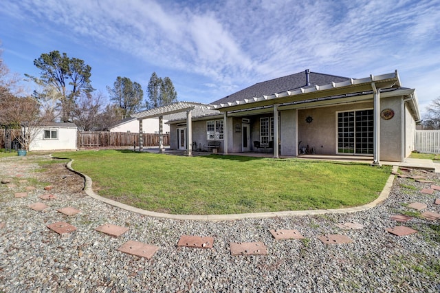 back of property with a pergola, a yard, a patio, and a storage unit