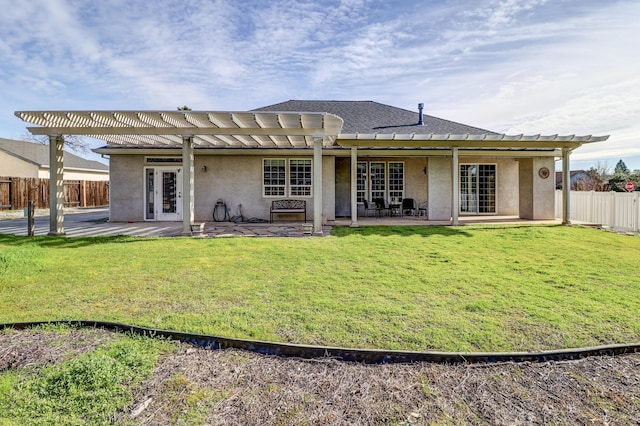 back of property with a yard, a patio area, and a pergola