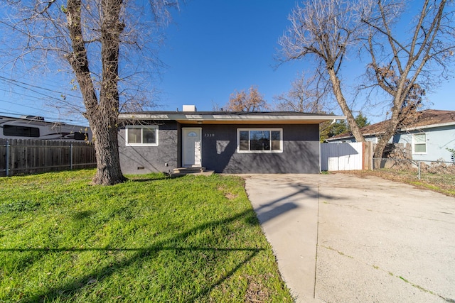 ranch-style home with a front lawn