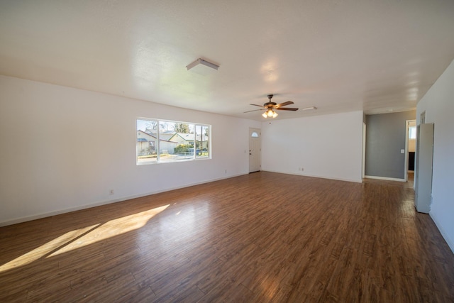 spare room featuring ceiling fan and dark hardwood / wood-style flooring