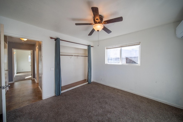 unfurnished bedroom with dark colored carpet, ceiling fan, and a closet