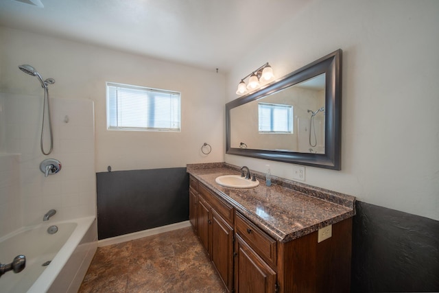 bathroom featuring a healthy amount of sunlight, shower / bathing tub combination, and vanity