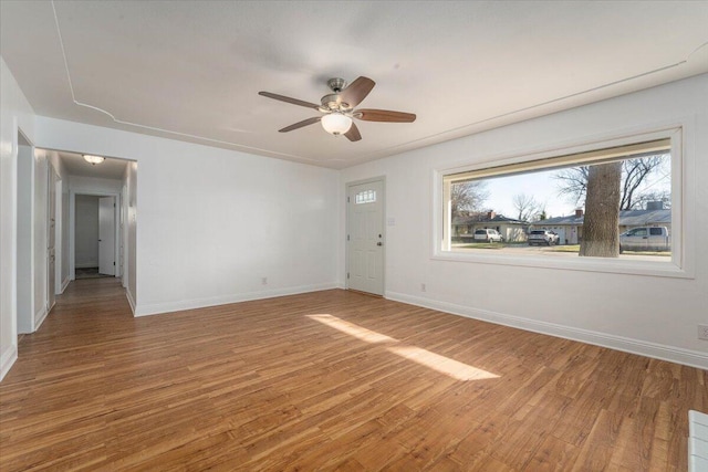 empty room featuring hardwood / wood-style flooring and ceiling fan