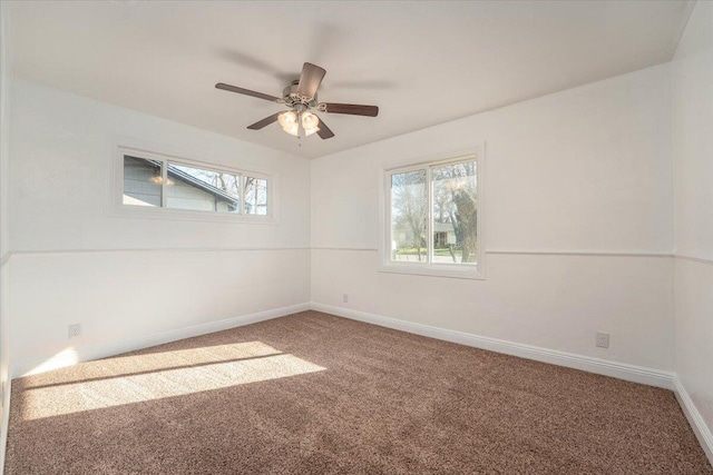 spare room featuring carpet floors and ceiling fan