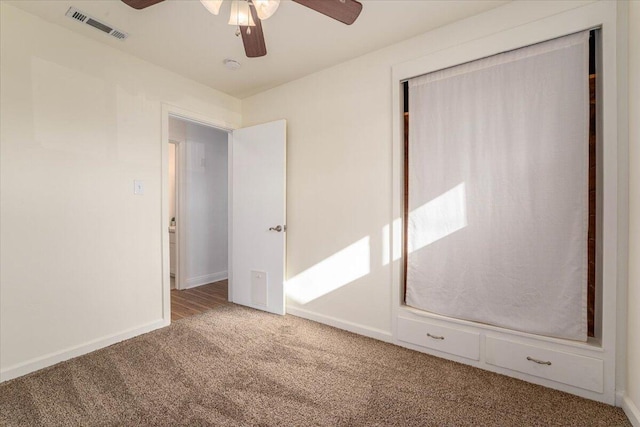 unfurnished bedroom with carpet flooring, ceiling fan, and a closet